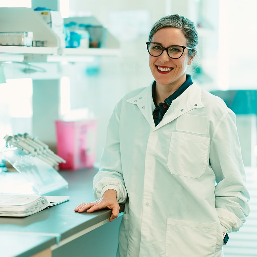 Researcher in white lab coat.