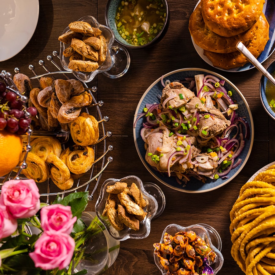A table top view of an array of sweet and savoury dishes made for a traditional feast to celebrate Eid al-Fitr the end of Ramadan.
