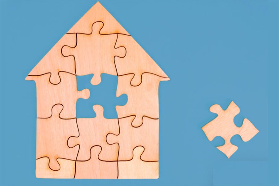 house as puzzle with missing puzzle piece and missing puzzle piece to the side