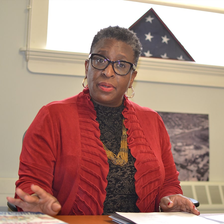 Yvonne Spicer sits at desk in Framingham, Ma.