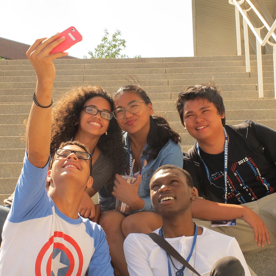 early college diverse students taking group selfie