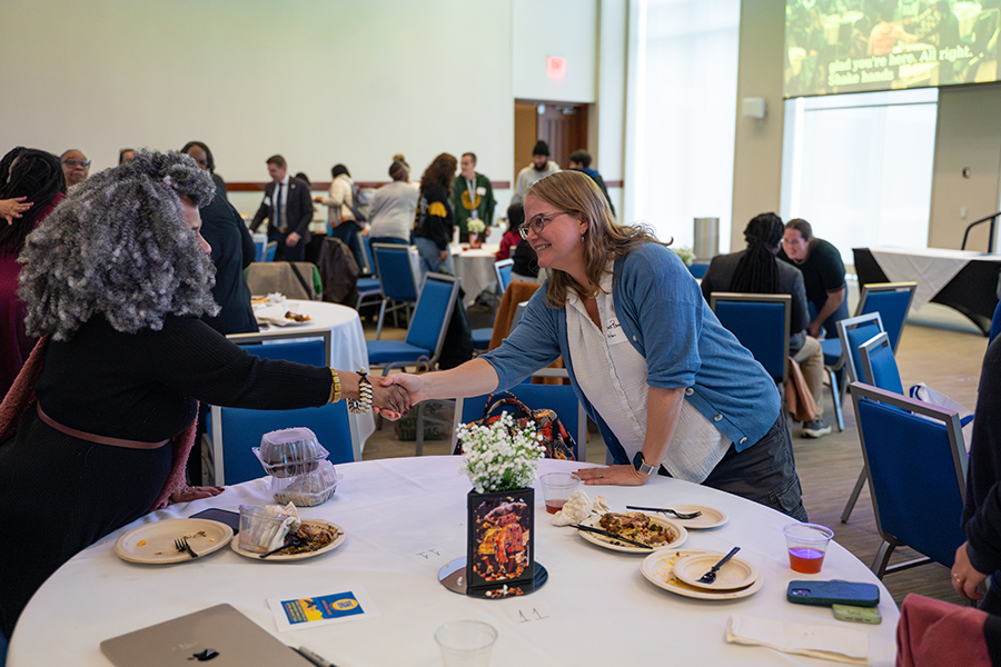 Two participants shaking hands at BLM Day