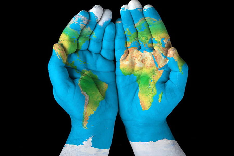 conceptual image of hands painted with global over them