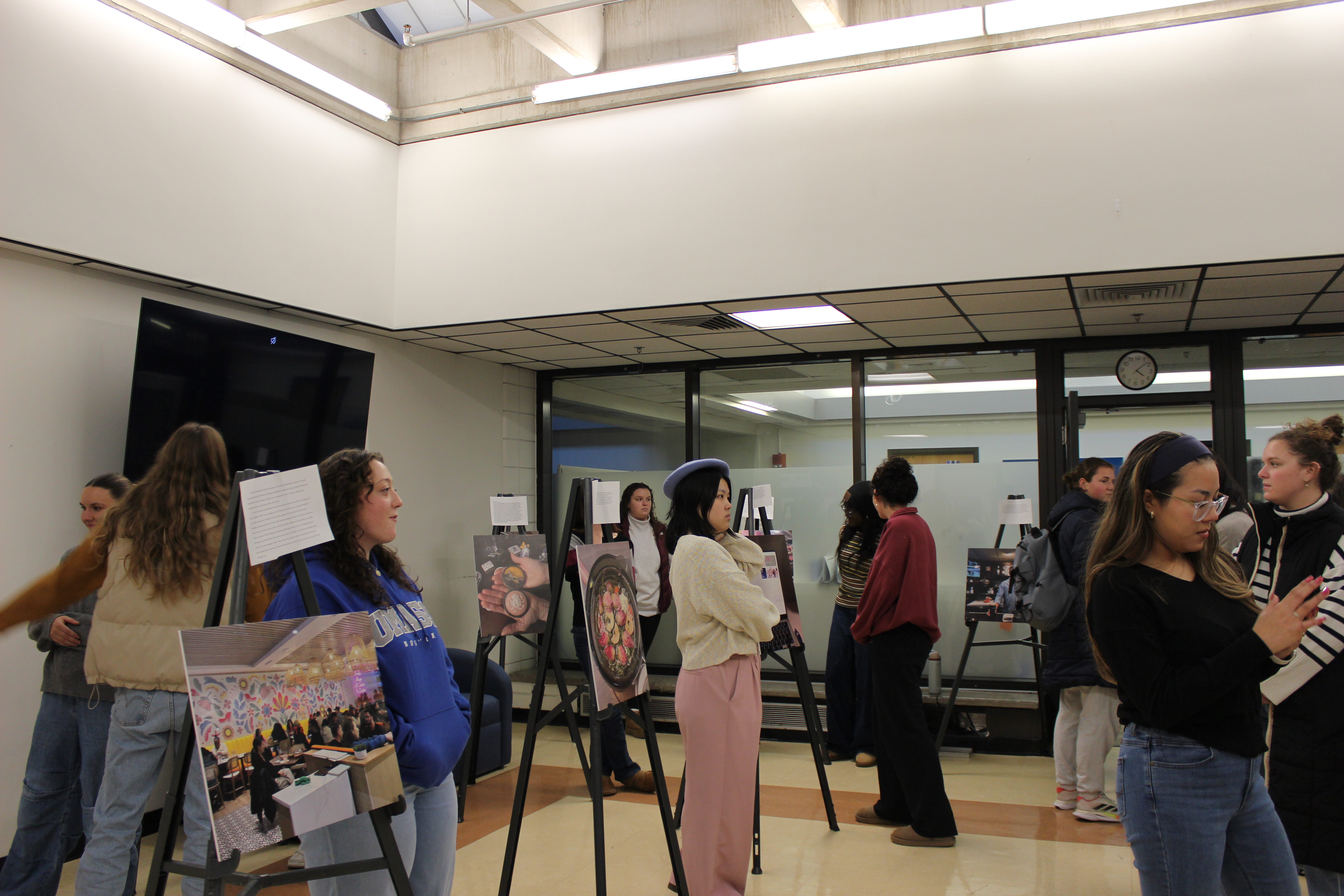 students standing by their photos
