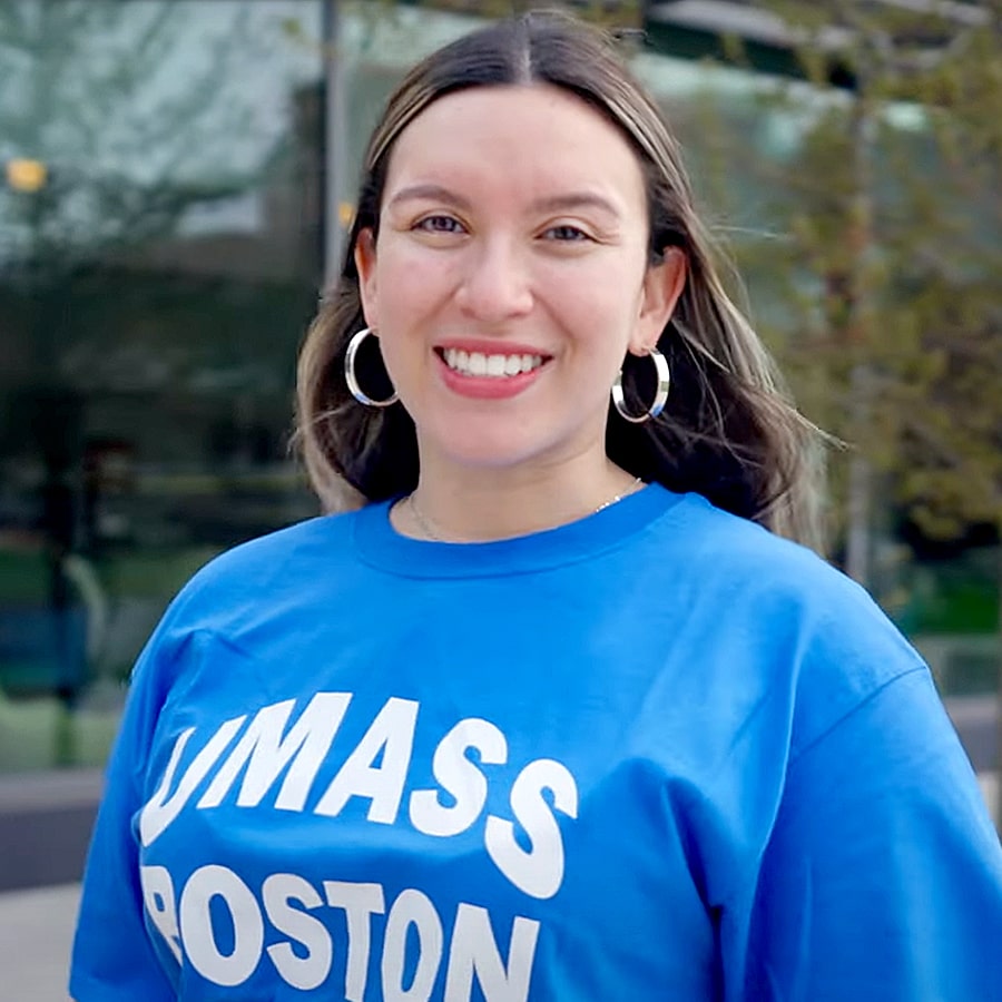 UMass Boston student Olivia smiles by the residence halls